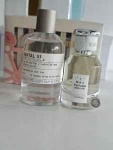 Side-by-side cost and concentration comparison of a traditional $300 luxury sandalwood perfume and the factory-direct imixx No. 62 alternative.