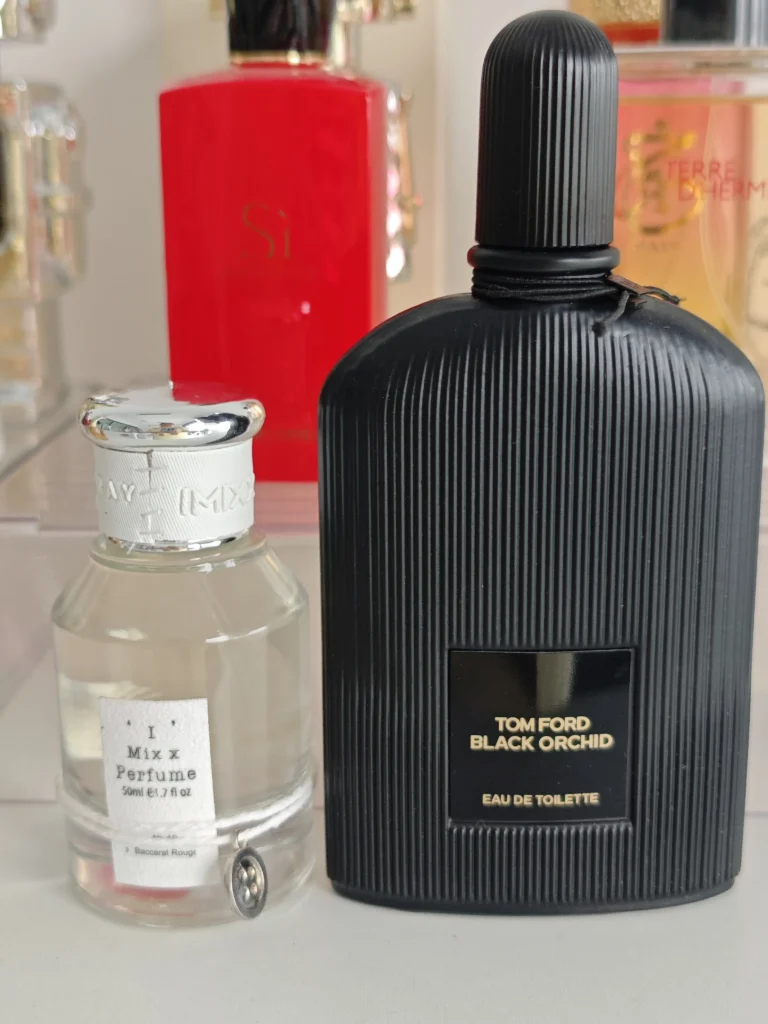 Side-by-side comparison of an expensive designer dark floral perfume and a high-quality Tom Ford Black Orchid dupe bottle.