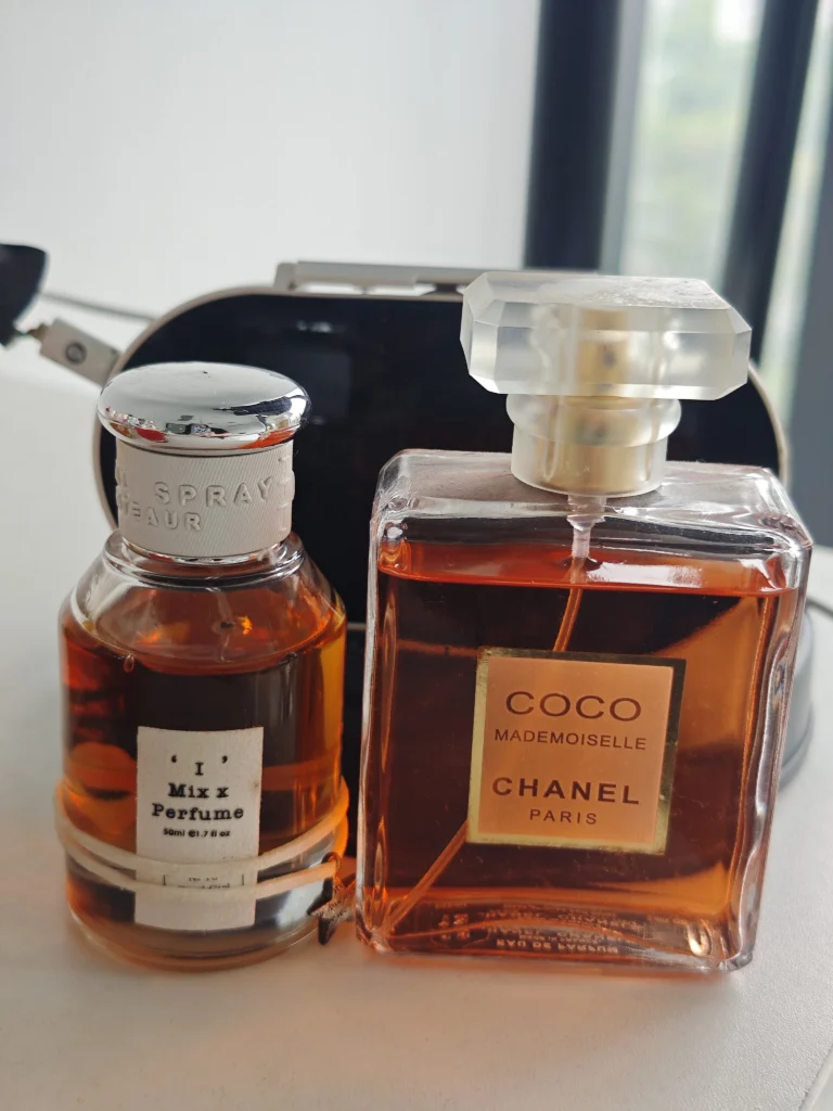 How to Find the Perfect Chanel Coco Mademoiselle Dupe in 2026 (And Smell Expensive for Less) 9 Side-by-side visual comparison of a traditional luxury designer perfume bottle and an affordable factory-direct alternative fragrance on a vanity