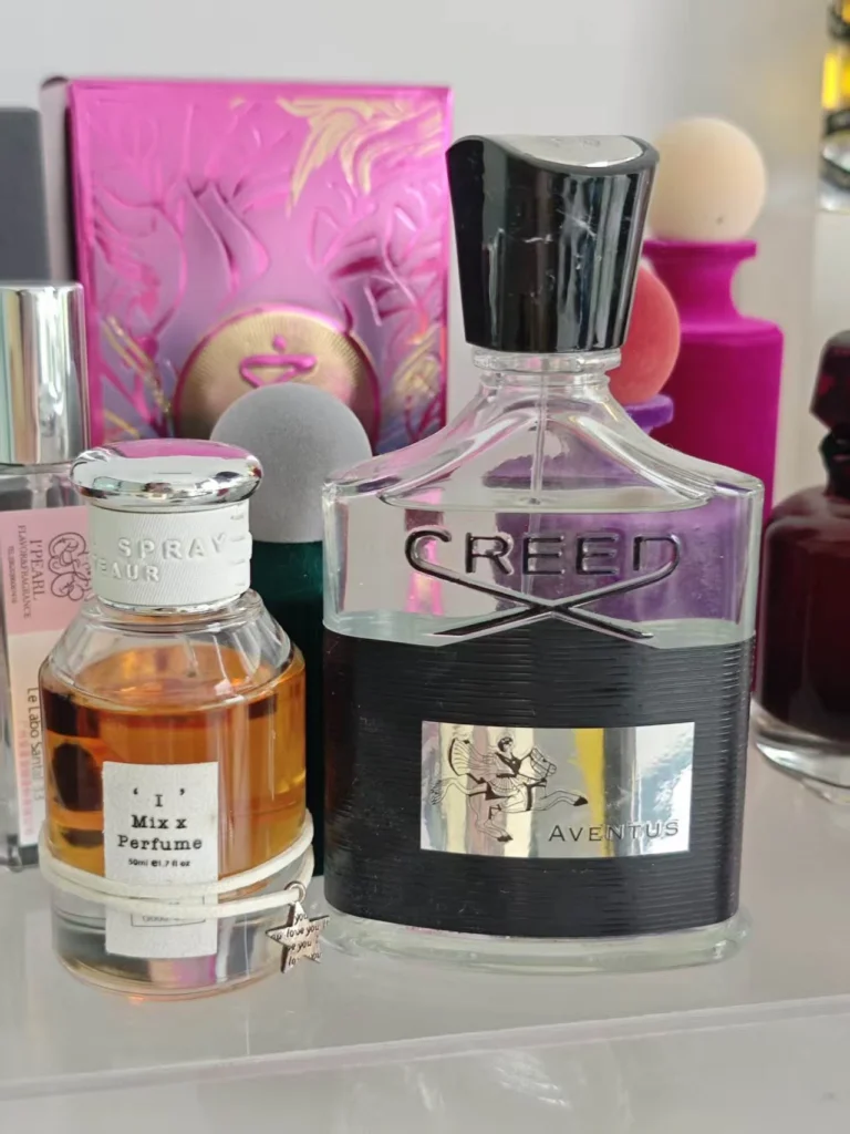 Side by side comparison of a high-end luxury cologne and a premium Aventus Creed copy showing cost and formulation differences.