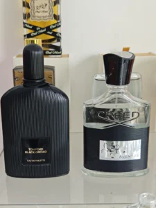 How to Find the Best Creed Aventus Dupe in the USA (2026 Guide) 3 Imixx No. 35 perfume bottle next to a traditional high-end designer cologne, illustrating the cost difference in fragrance packaging and supply chain.