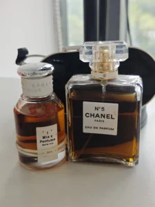 How to Find the Best Chanel No. 5 Dupe in the USA: A Supply Chain Expert's Guide 2 Side-by-side comparison of an expensive luxury floral designer perfume bottle and the affordable Imixx No 25 Chanel No 5 dupe alternative.