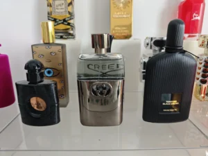 Side-by-side comparison of a $300 luxury designer cologne and an affordable premium clone fragrance alternative.