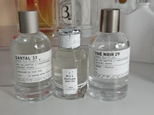 Cost breakdown visualization comparing a premium designer fragrance bottle with a lab-formulated imixx perfume alternative.