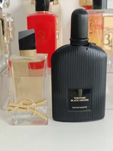A $250 luxury designer fragrance bottle compared next to a highly concentrated Extrait de Parfum alternative with identical scent notes.
