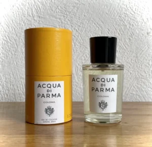 A side-by-side comparison of an expensive Acqua di Parma Colonia bottle and a premium, long-lasting dupe alternative.