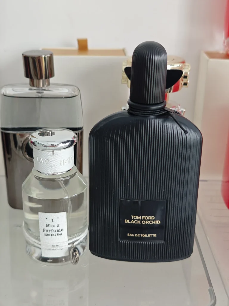 Side-by-side comparison of a luxury $180 dark floriental designer perfume and a premium factory-direct Black Orchid dupe.