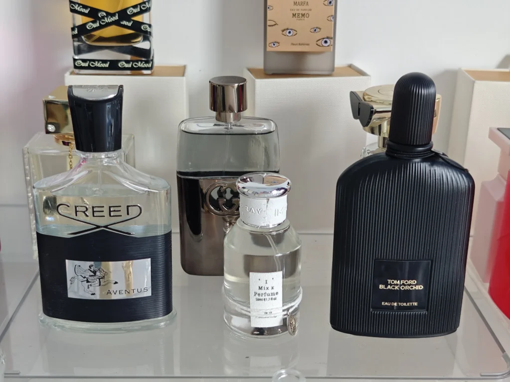 A side-by-side cost and quality comparison between a $300 traditional luxury designer fragrance and an affordable high-quality cologne dupe bottle.