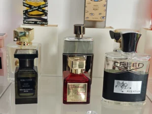 A side-by-side comparison of an expensive luxury designer cologne and a high-quality affordable dupe alternative.