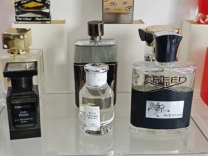 Comparing a $300 traditional luxury fragrance bottle with a $39 premium factory-direct dupe cologne.