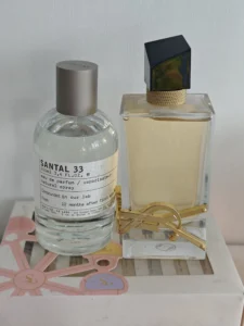 How to Find the Best Dupes Perfume in the USA: An Industry Insider's Guide to High-End Alternatives 3 Visual comparison showing an expensive high-end fragrance next to a premium direct-to-consumer perfume dupe on a vanity.