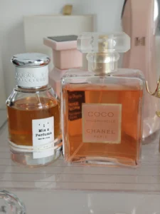 Price and packaging comparison between a traditional luxury fragrance and an affordable direct-to-consumer perfume alternative.