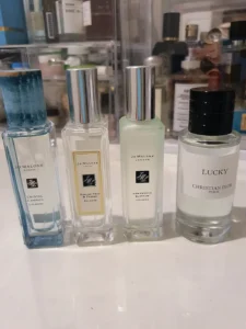 Visual cost breakdown comparing an expensive luxury designer fragrance with an affordable direct-to-consumer perfume alternative