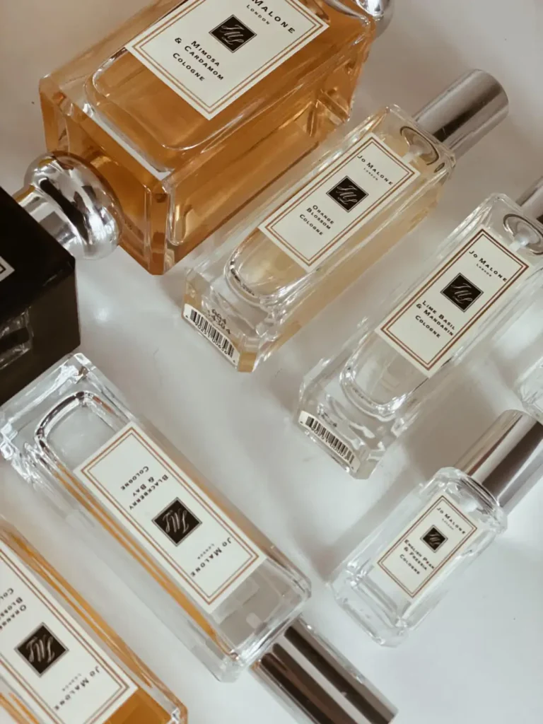 Side-by-side comparison of an original Jo Malone cologne bottle and a long-lasting EDP perfume dupe