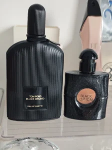 Side-by-side visual comparison of an expensive designer fragrance and a high-quality YSL Black Opium dupe bottle.