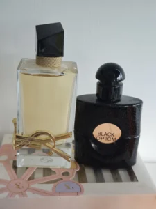 Side-by-side visual comparison of a high-end YSL Libre designer perfume bottle and a minimalist, factory-direct Eau de Parfum alternative.
