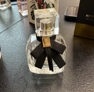 Side-by-side comparison of a $160 designer YSL Mon Paris perfume bottle and a high-quality affordable Extrait de Parfum alternative.